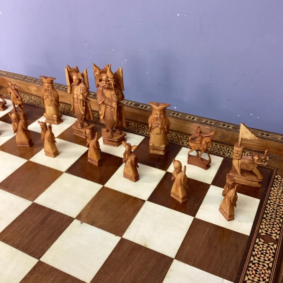 Hand Made Wooden Chess Board + Oriental Carved Chess Set Pieces featuring intricately carved chess pieces on a luxurious board.
